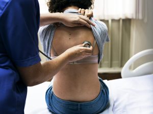 Doctor checking a breathing of a patient